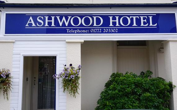 Blue and white Ashwood Hotel exterior sign.