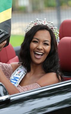 Caribbean Carnival 2017 Queen smiling and waving from car, with crown on head.