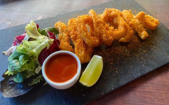 A serving plate of Crispy Prawns, salad and sweet chilli dipping sauce