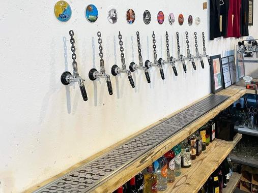 A row of beer taps behind a bar at Chain House Brewing Co.