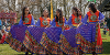 Preston City Mela dancers in brightly coloured blue and orange dresses dancing to a crowd