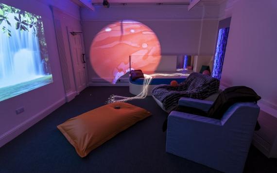 The Space Centre's Sensory Room 1 featuring padded chairs and pillows to view wall projections