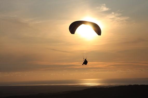 Paraglider over Parlick Hill at sunset