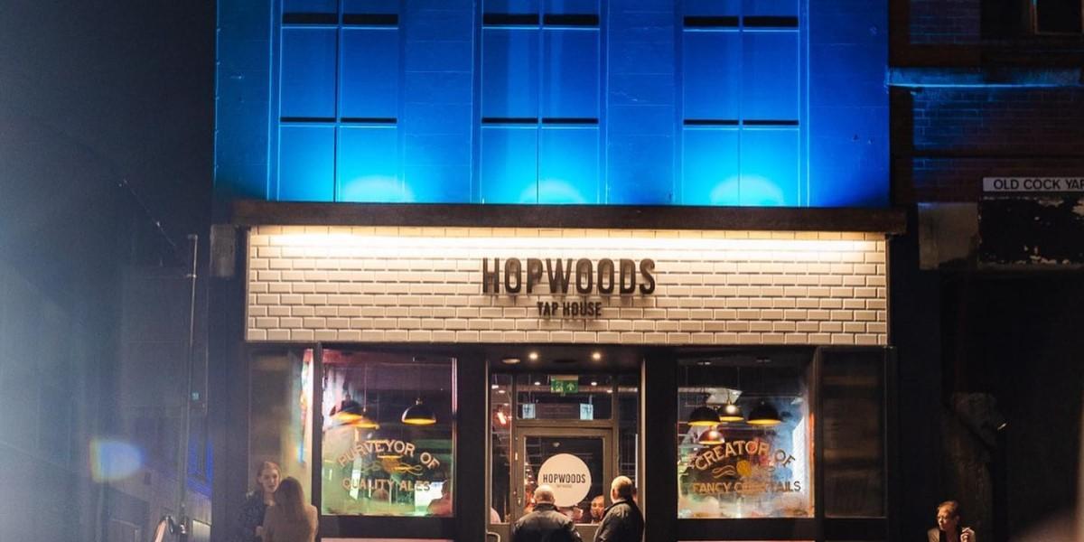 Outside Hopwoods Tap House lit up blue at night