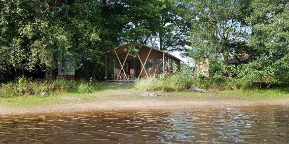 Feather down tent on the lake shore