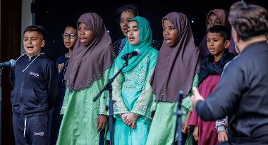 Children singing on stage outside the Guild Hall