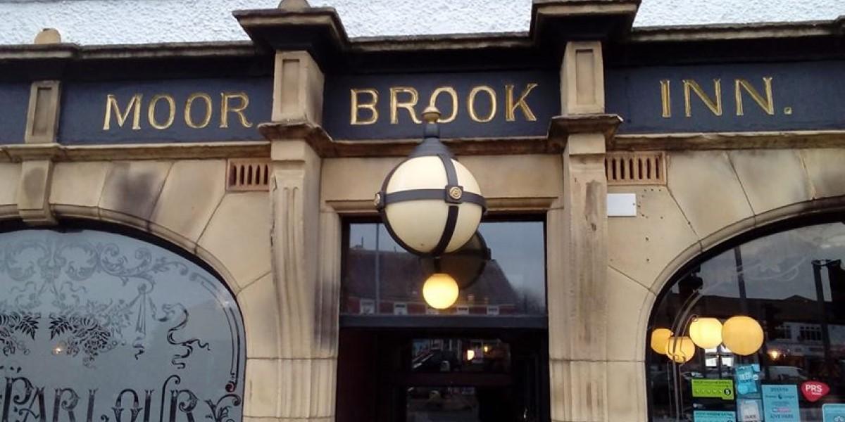 The sign outside and above the door of The Moorbrook Inn pub