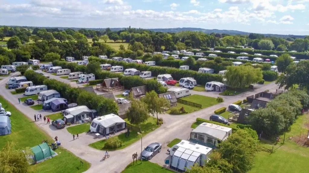 Aerial view of caravan and motorhome space in countryside surrounding