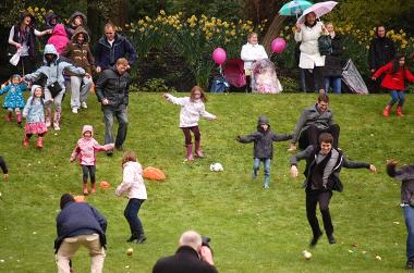 People rolling eggs down a hill