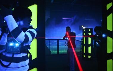 Boy getting ready to shoot opponent inside Laser Quest arena