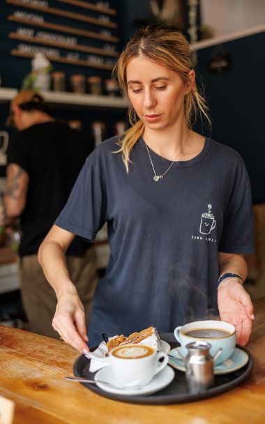 Waitress serving coffee and cakes