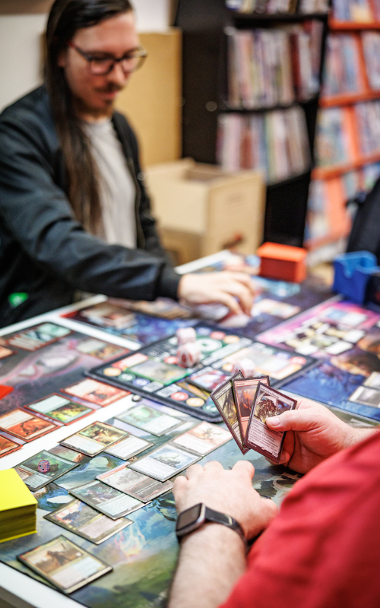 Close up of young people playing card game