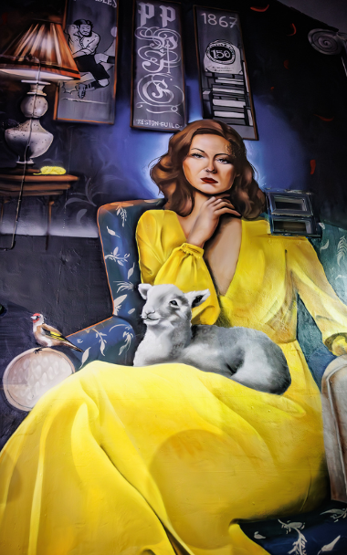 Mural of lady with lamb on lap