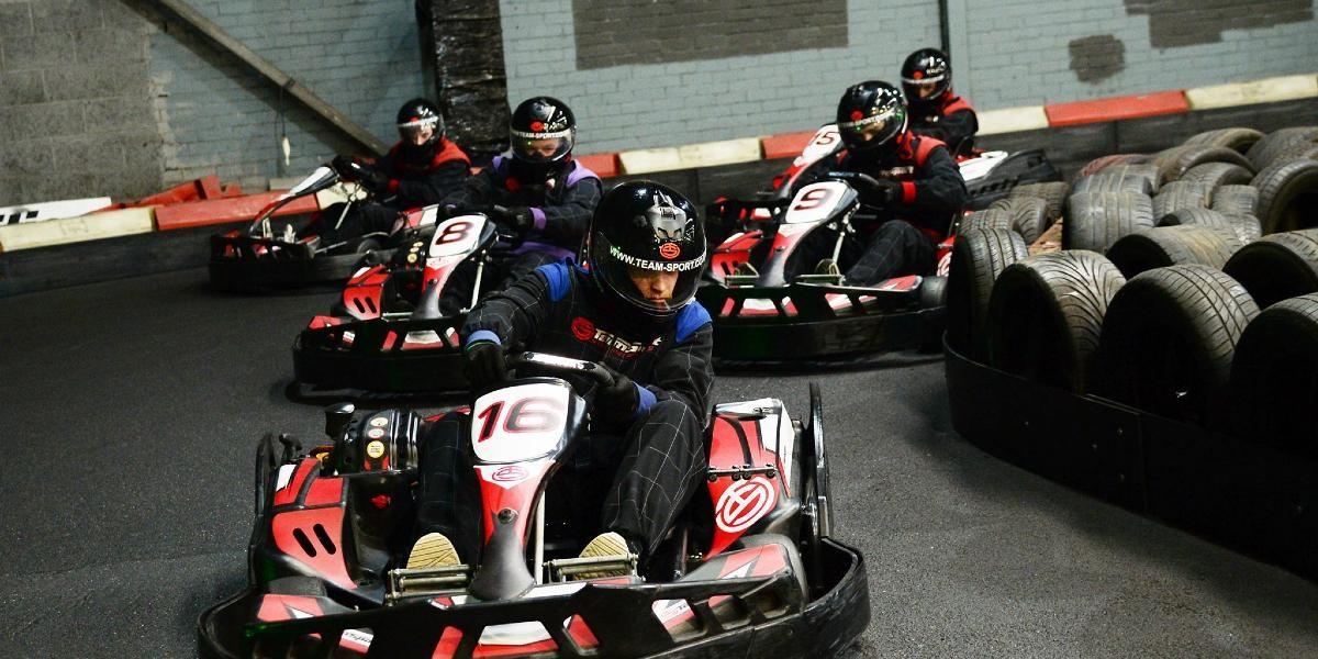 People in go-karts racing around a track