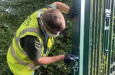 Park Ranger removing graffiti