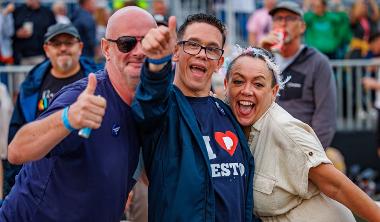 People in crowd giving thumbs up