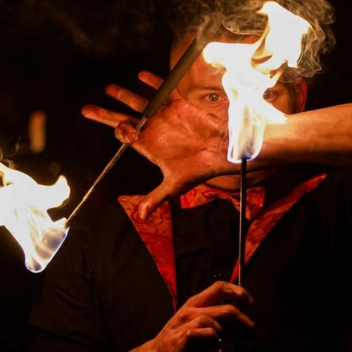 A man holding fire at a Fire Show.