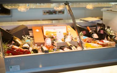 Various wines on display in a glass cabinet at the Italian Orchard restaurant