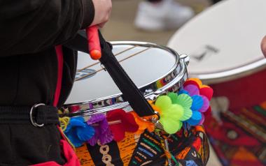 A close up of a drum decorated with rainbow coloured flowers at the Pride Parade