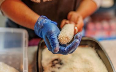 Coating a corndog with batter and breadcrumbs