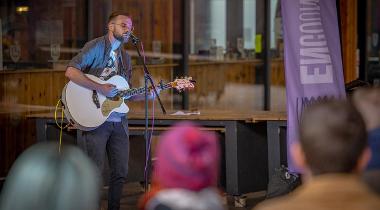 A man playing his guitar and singing at the Encounter Festival