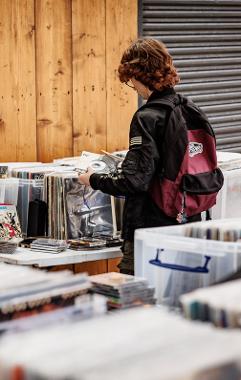 Young adult browsing through records at Preston Markets