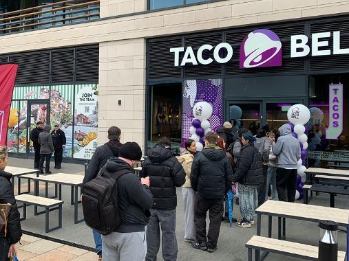 People queuing at entrance to Taco Bell