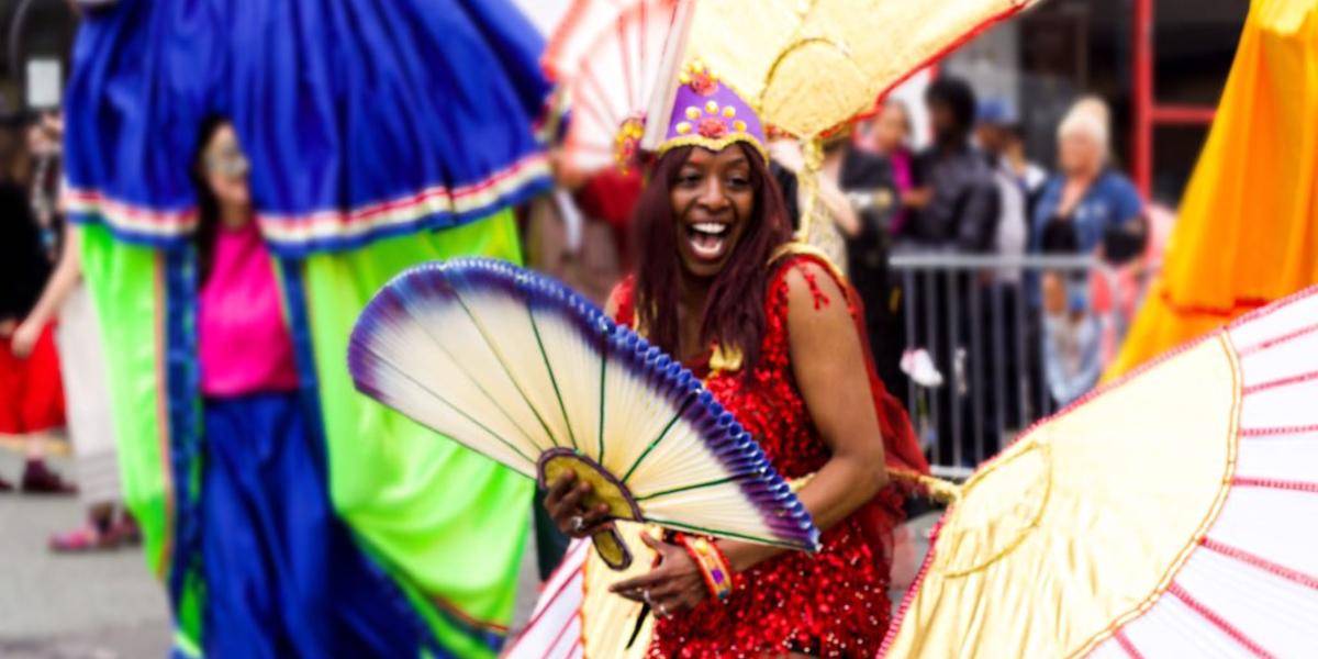 Main image: Woman dressed in colourful costume whilst attending Preston's Caribbean Carnival. Woman dressed in colourful costume whilst attending Preston's Caribbean Carnival.
