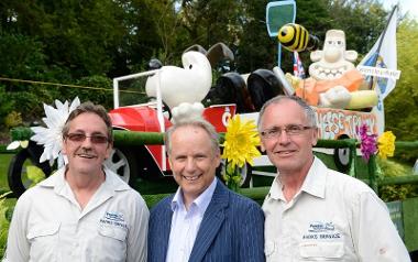 Nick Park stood by Wallace and Gromit float with parks service team members.