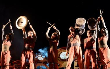 Performers with drumsticks and cymbals on stage during Preston Guild 2012.