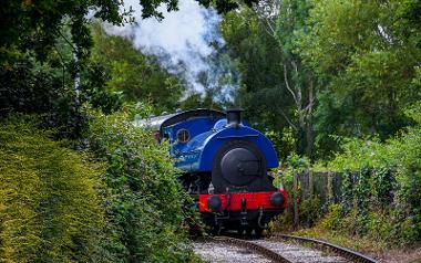 Blue steam train on tracks at Ribble Steam Railway.