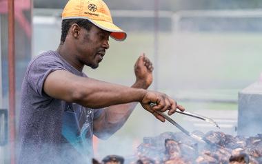 Food vendor cooking food at Preston Caribbean Carnival.