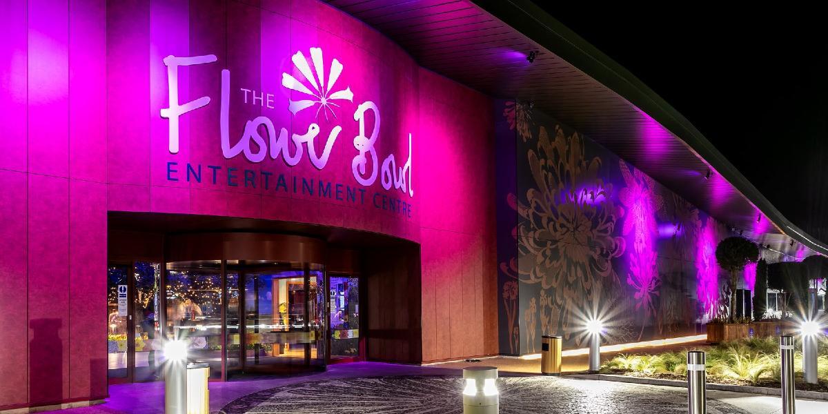Main image: Flower Bowl Entertainment Centre entrance lit up in pink. Flower Bowl Entertainment Centre entrance lit up in pink.