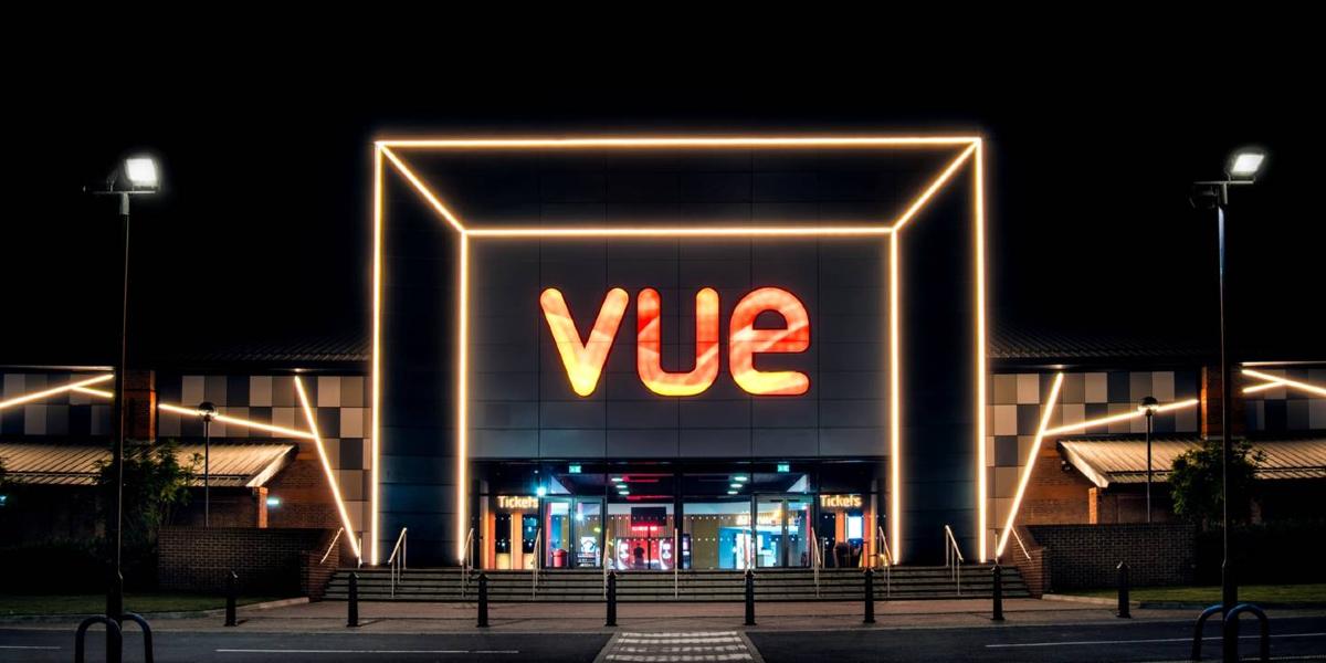 Entrance to Vue Preston cinema, lit up at night.