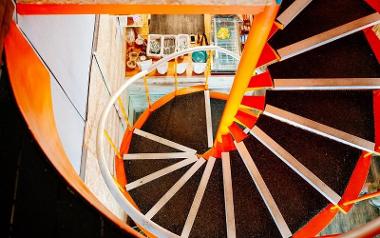 View down Cafune's vibrant orange staircase.