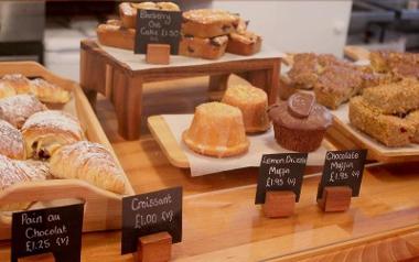 Cakes on display inside Origin Juice and Brew Bar.