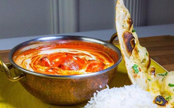 Curry dish on table inside Sai Surbhi, Preston.