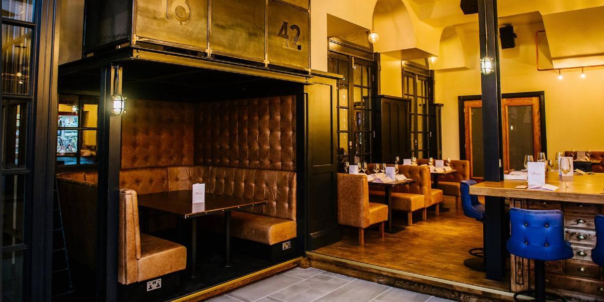Main image: Booth and dining area inside 1842 Bar and Restaurant. Booth and dining area inside 1842 Bar and Restaurant.