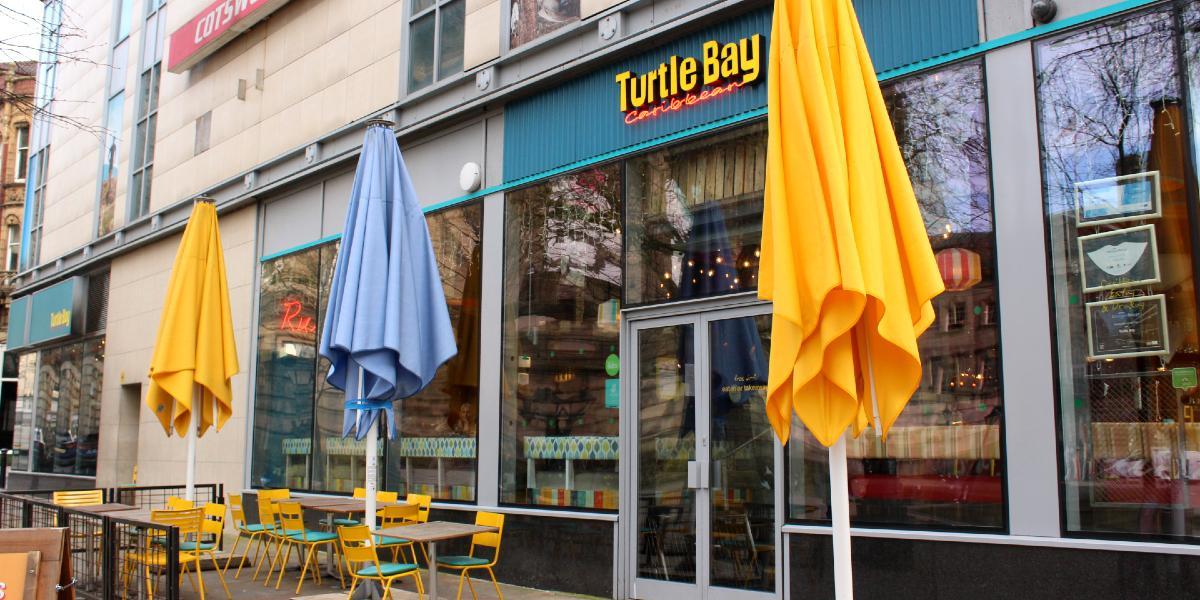 Main image: Colourful umbrellas and outdoor seating on Preston Flag Market outside Turtle Bay Restaurant. Colourful umbrellas and outdoor seating on Preston Flag Market outside Turtle Bay Restaurant.
