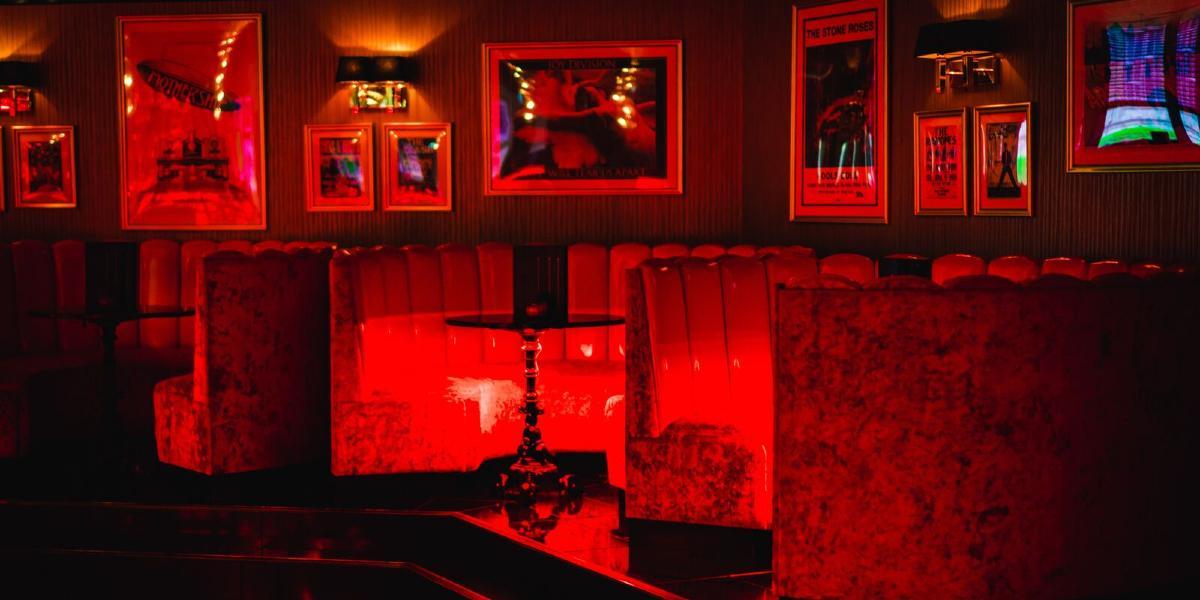 Main image: Booths lit up in red inside Kuckoo Preston. Booths lit up in red inside Kuckoo Preston.