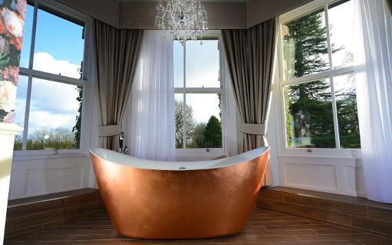 Copper bath by windows in Bartle Hall hotel room.