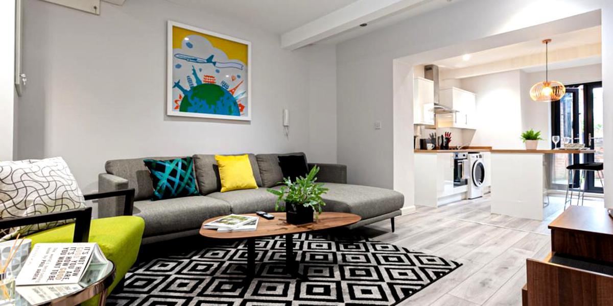 Corner sofa in bright and modern living room at City Haven apartment.