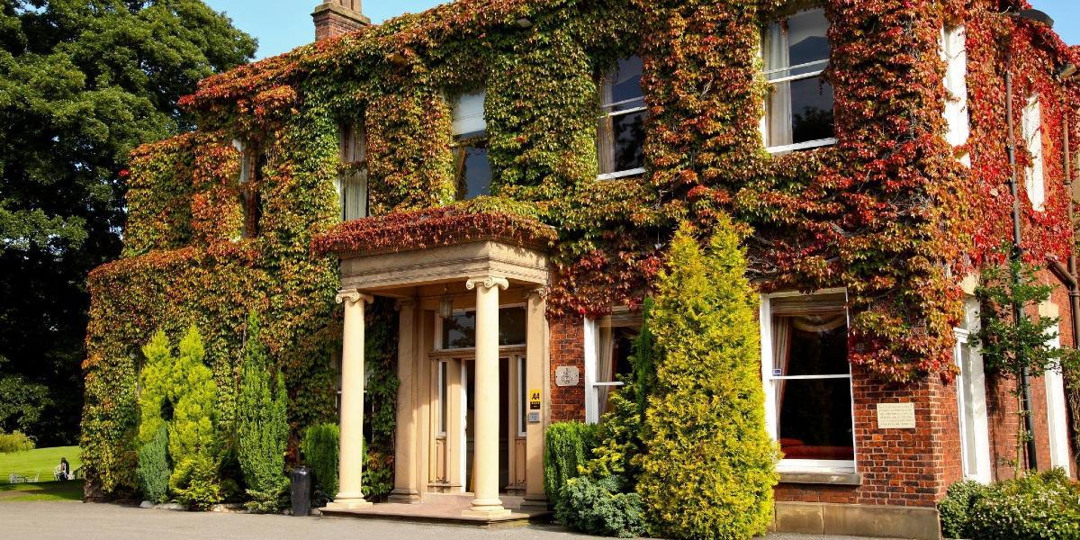 Farington Lodge front entrance, covered in colourful ivy.