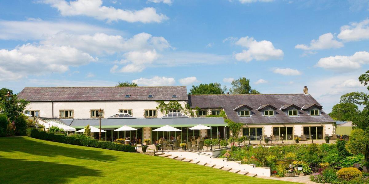Gibbon Bridge Hotel, gardens, and grounds on a sunny day. Gibbon Bridge Hotel, gardens, and grounds on a sunny day.