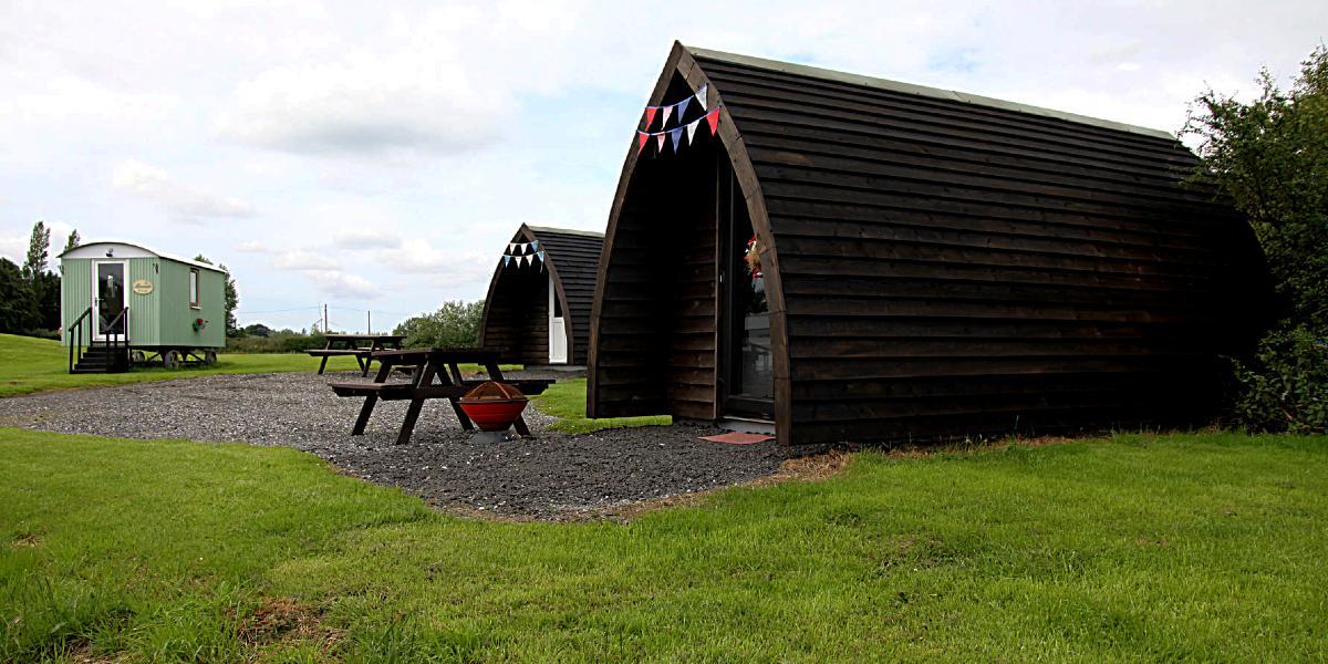 Two camping pods and a shepherd hut at Poplar Grove Farm.