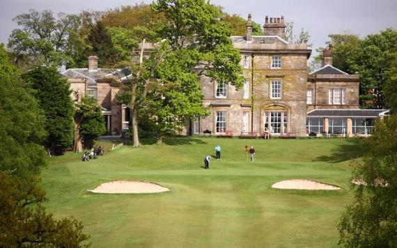 Shaw Hill Hotel and golfers on golf course.