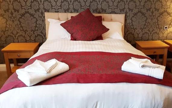 Villa Express double hotel bed with red furnishings.