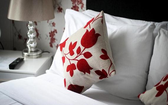 Close-up of cushions on bed at Whitburn House Hotel.