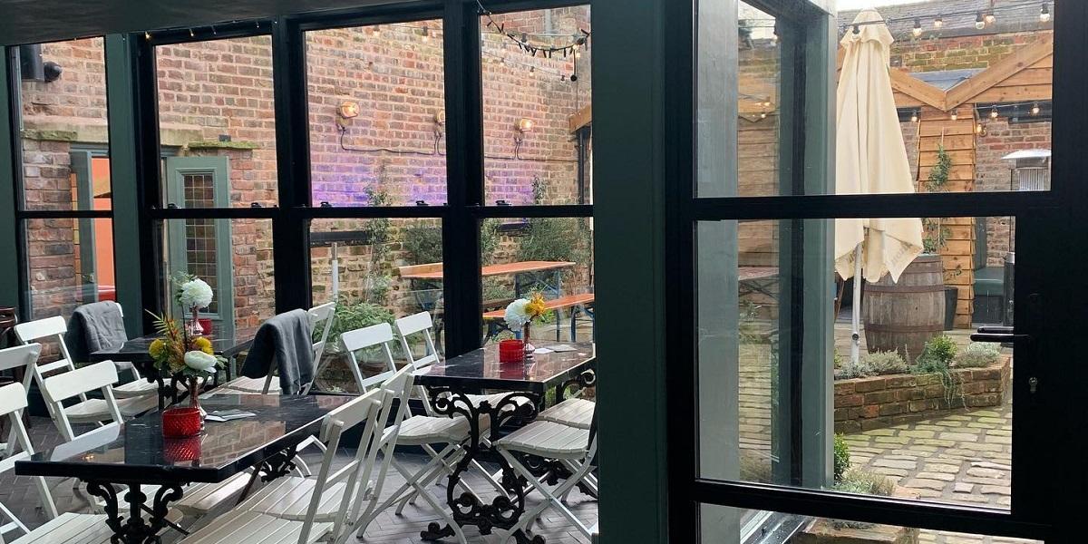 Main image: Inside seating area and view through glass doors. Once was Lost inside seating area and view through glass doors into courtyard.