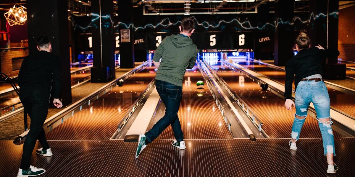 Three friends playing bowling in Level Preston.